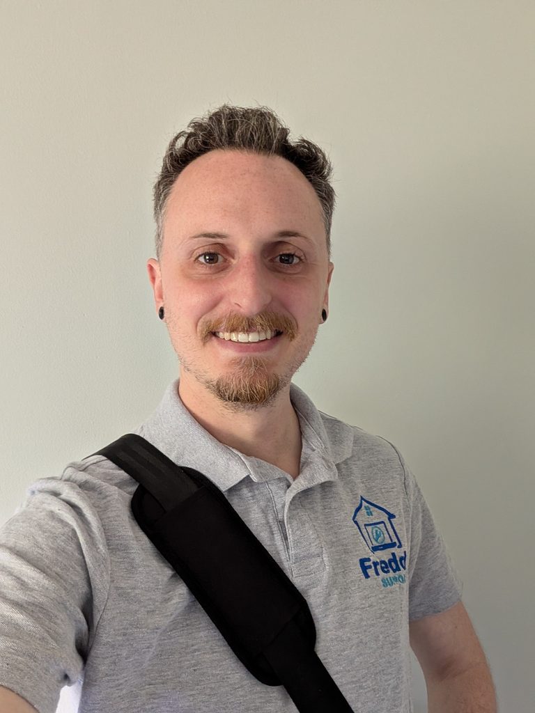 Jon, founder of Freddy Support, wearing a Freddy Support polo shirt